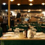 Warm and inviting Greek café interior with set dining tables in Athens, Greece.