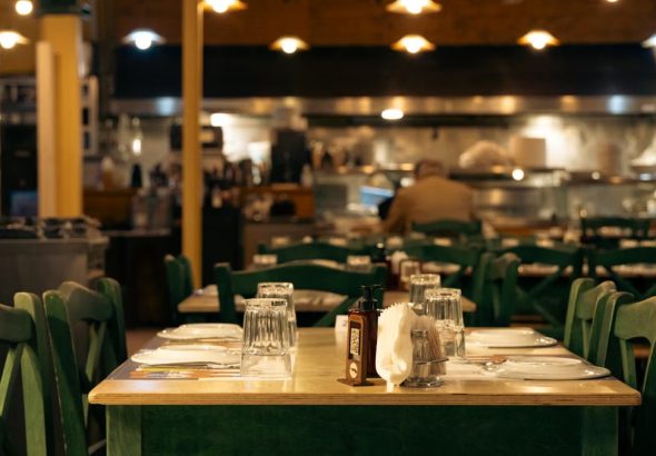Warm and inviting Greek café interior with set dining tables in Athens, Greece.