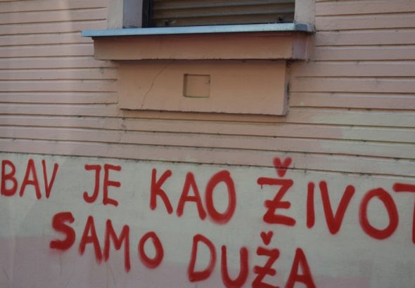 Red graffiti on a building wall