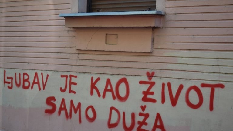 Red graffiti on a building wall